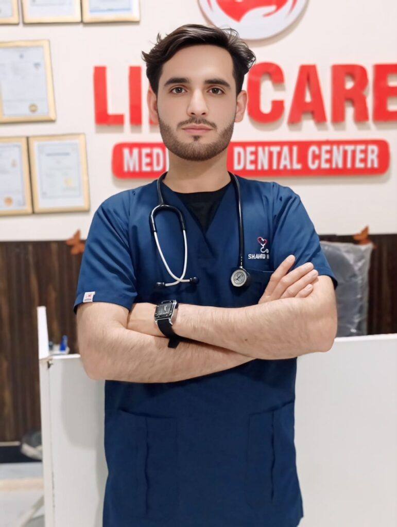 a man in blue scrubs with stethoscope around his neck